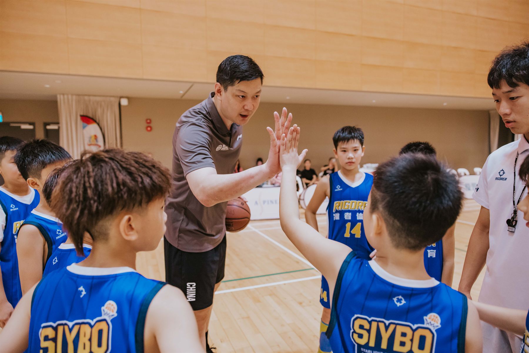 SIYBO 2024 coach high-five with team